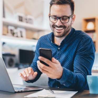 Smiling sales rep checking notification on phone
